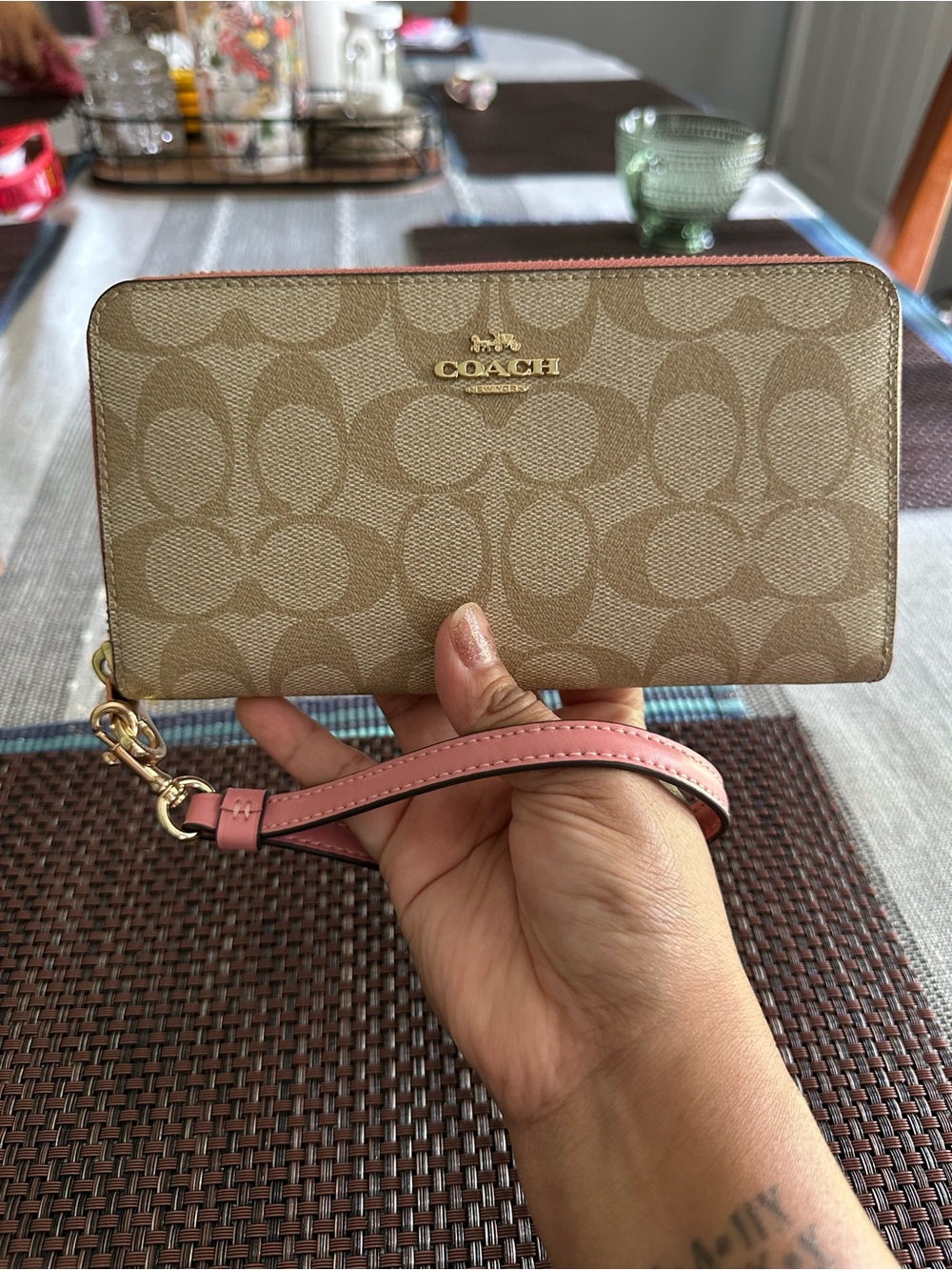 Coach Long Zip Around Wallet in signature canvas with a detachable wrist strap.